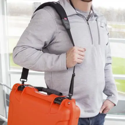 Nanuk Shoulder Strap attached to case being carried by a man.